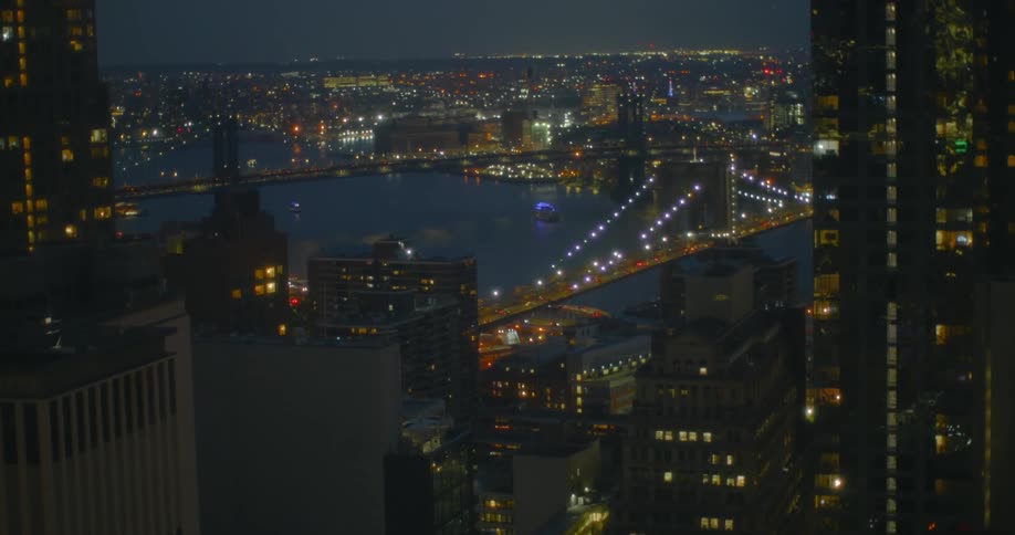 Aerial view of a downtown city at night is displayed
