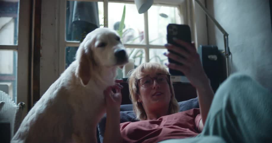 A woman laying down with her dog