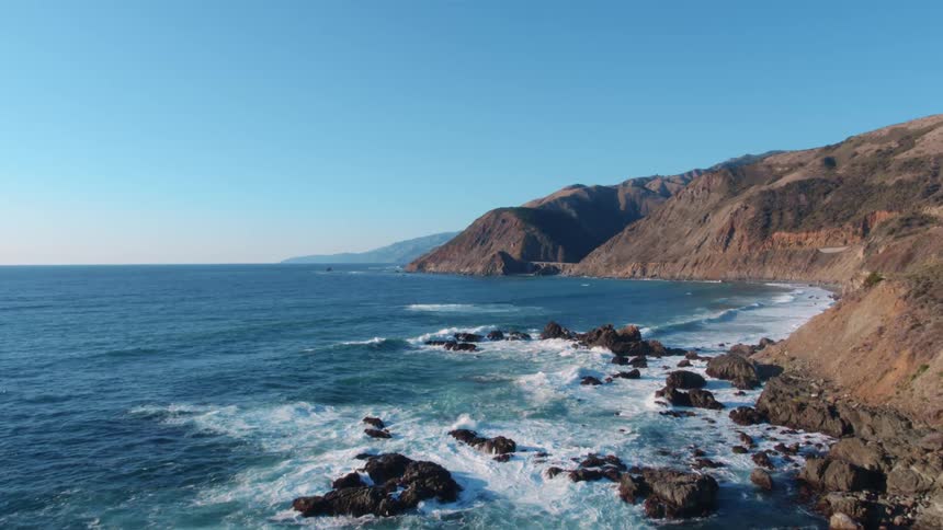 Ocean waves crash into a rocky shore