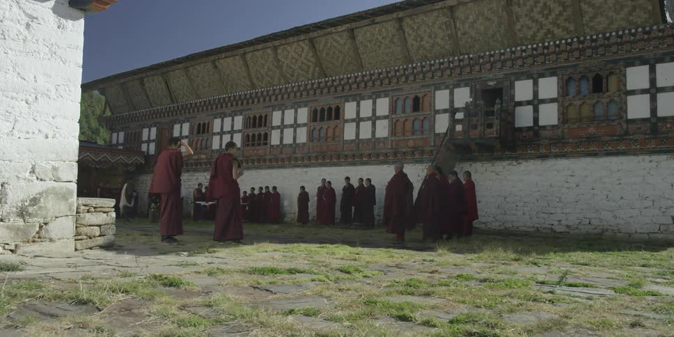 Monks gather outside their temple on a clear day