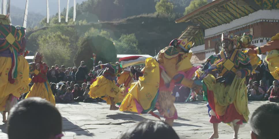 People in costumes are performing for a crowd