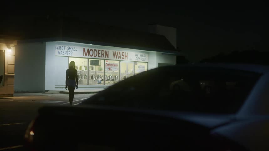A woman walks away from the landromat