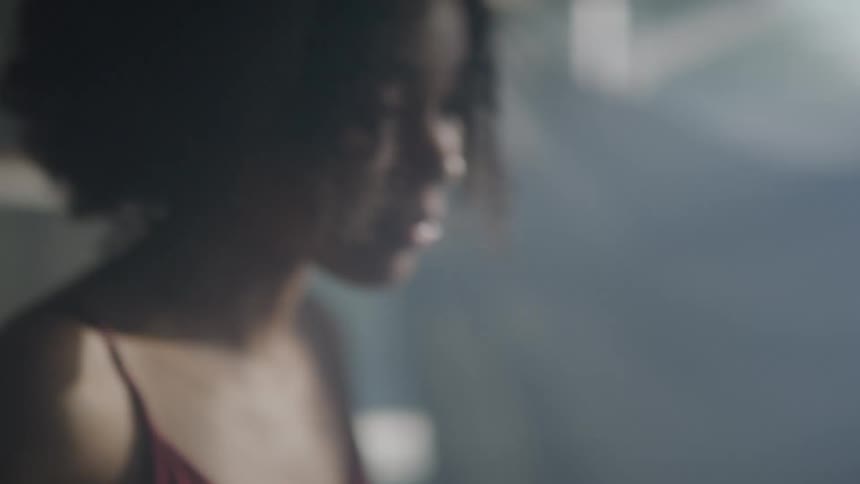 A woman is dancing in the foggy room
