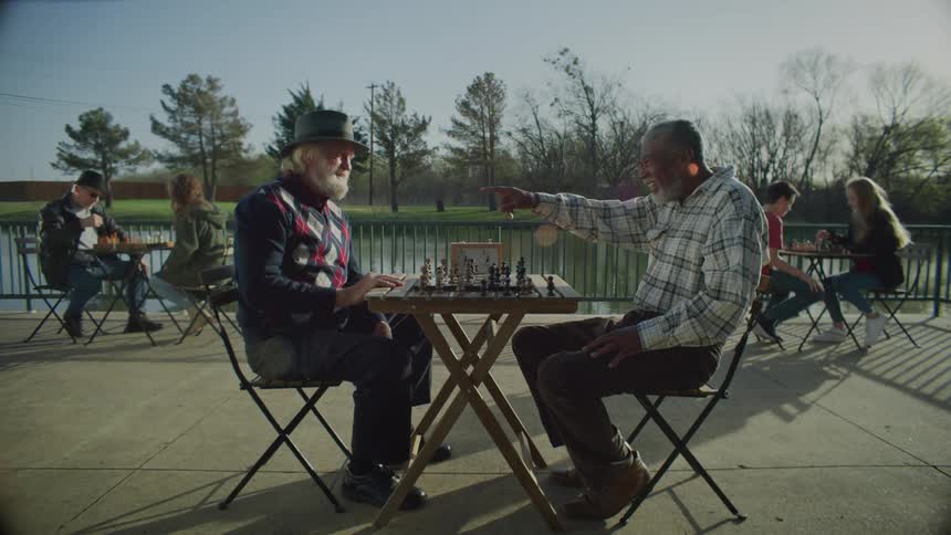 People are outside playing chess