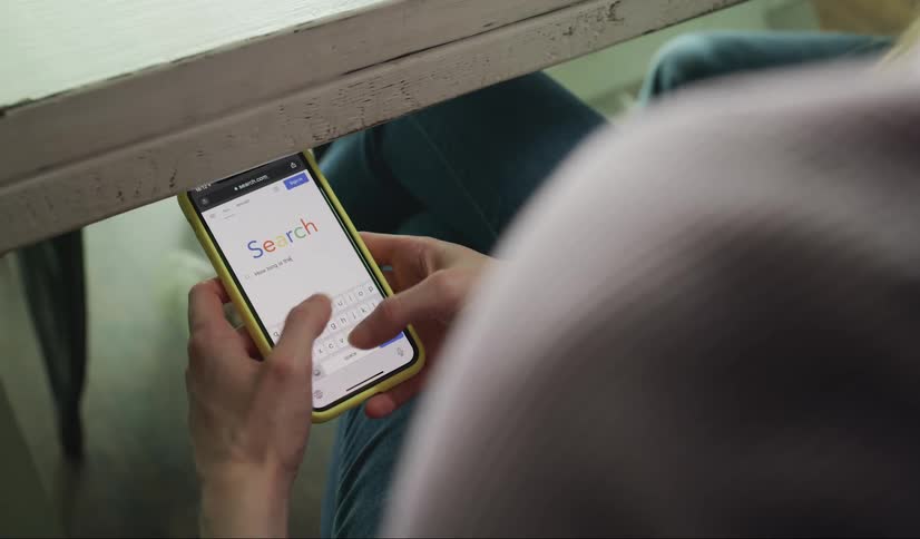 Woman does an online search on her cellphone