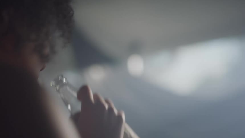 Woman drinks while dancing in smoky room