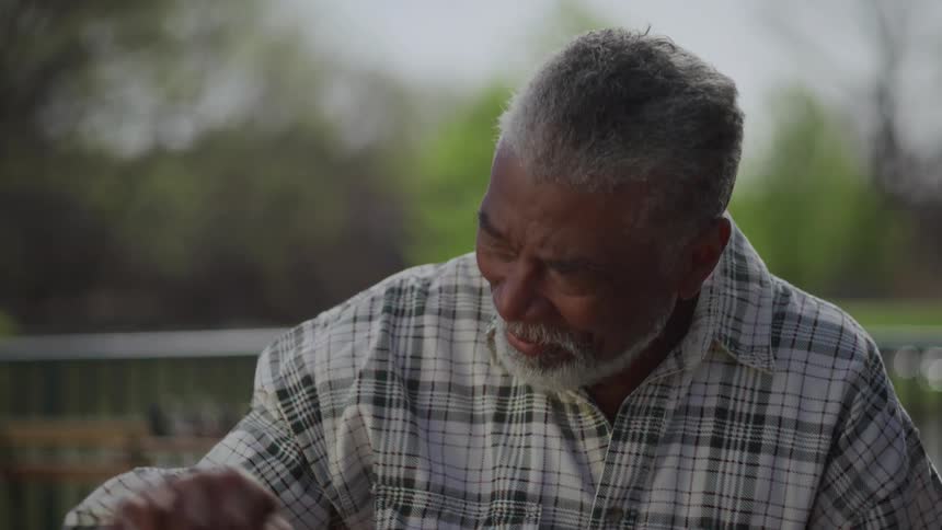 A man playing chess outdoors