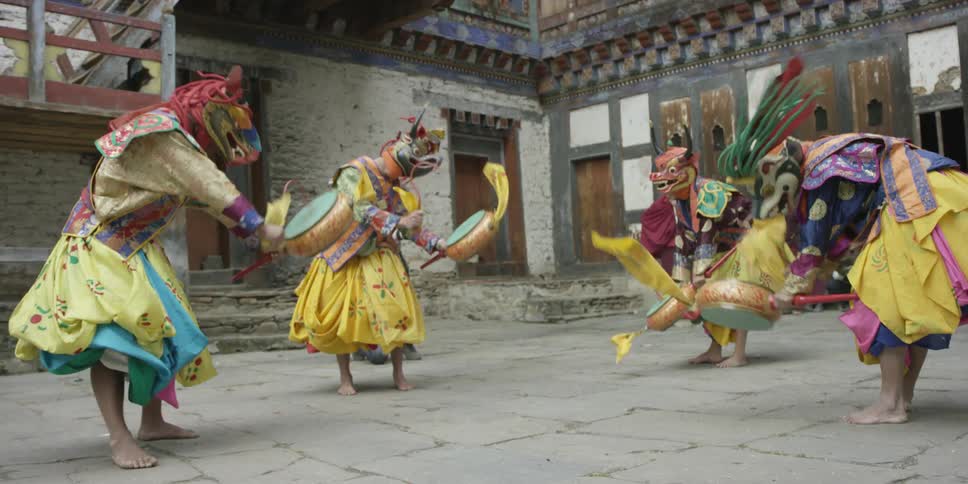 People in costume are performing for a photographer