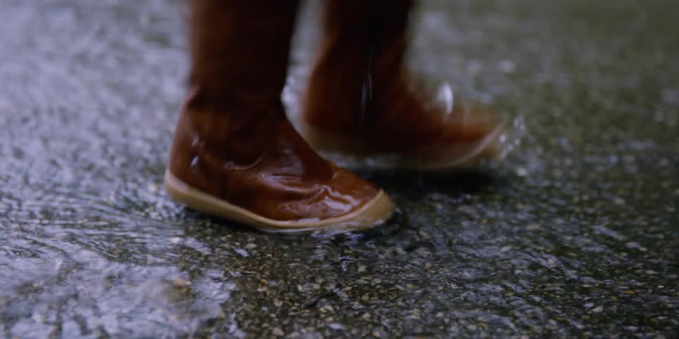A child stomping in puddles outdoors