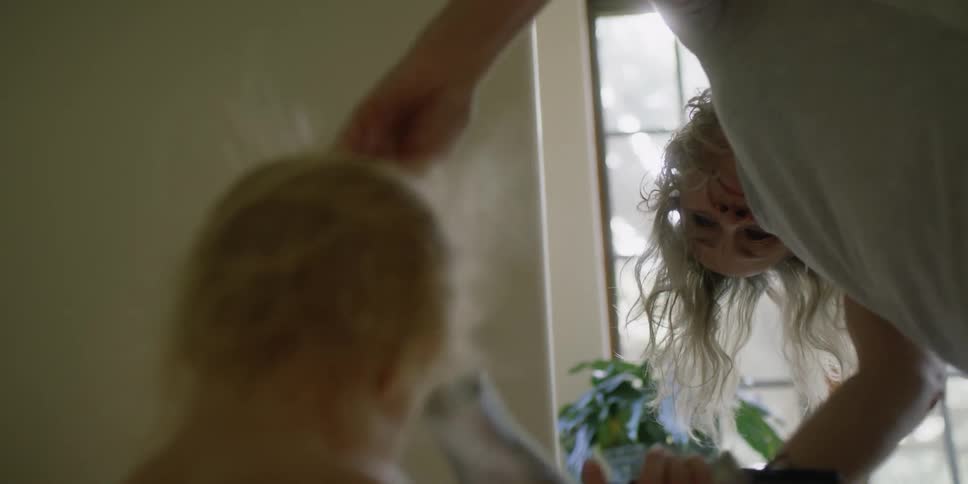 A mother drying their daughters hair