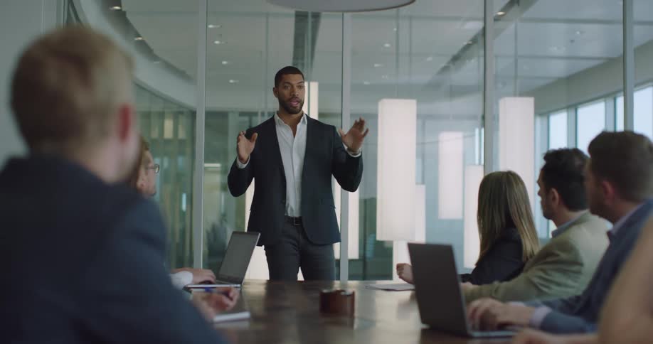 A boss giving a speech to a group of employees