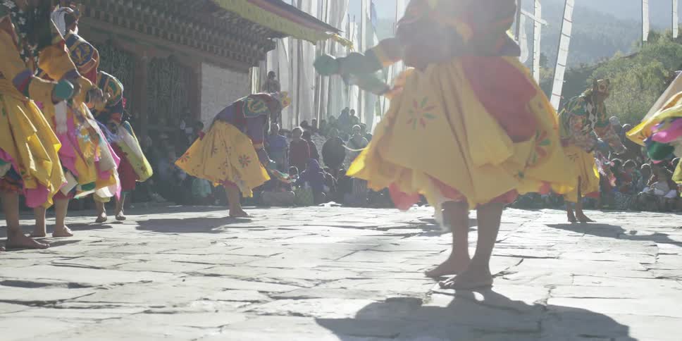 A group of people dance in the street