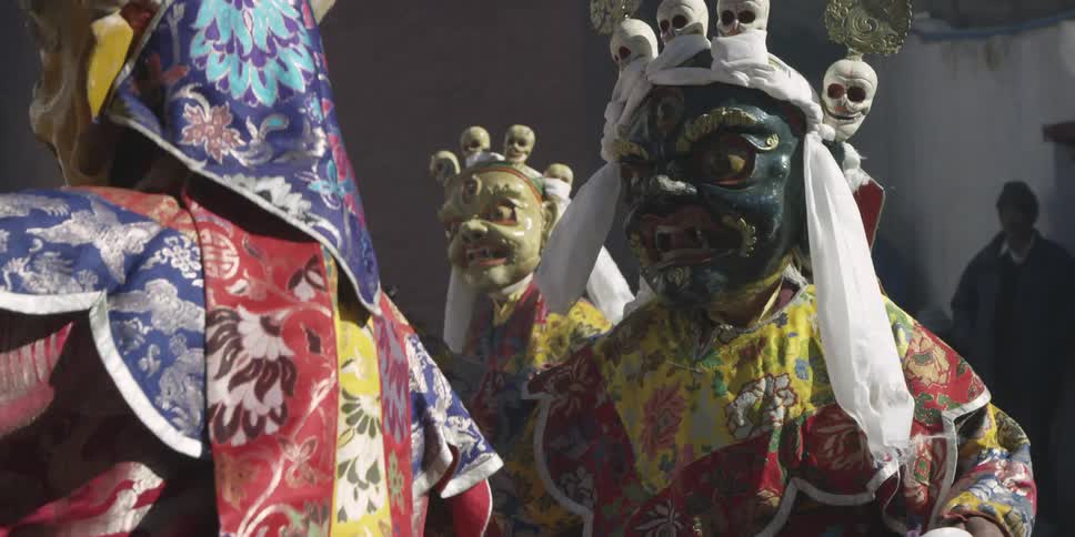 People in costumes dance for an audience