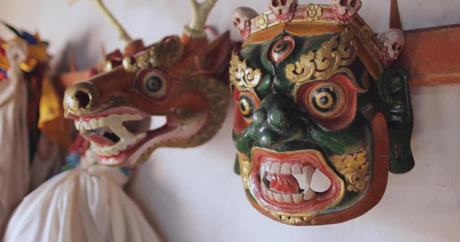 Close up of masks hanging on a wall