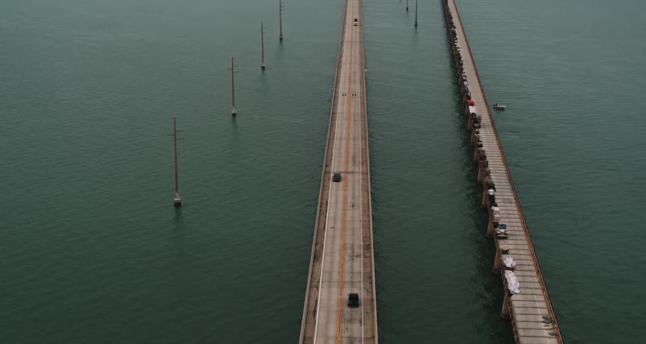 Cars traveling over a bridge near a coastal town