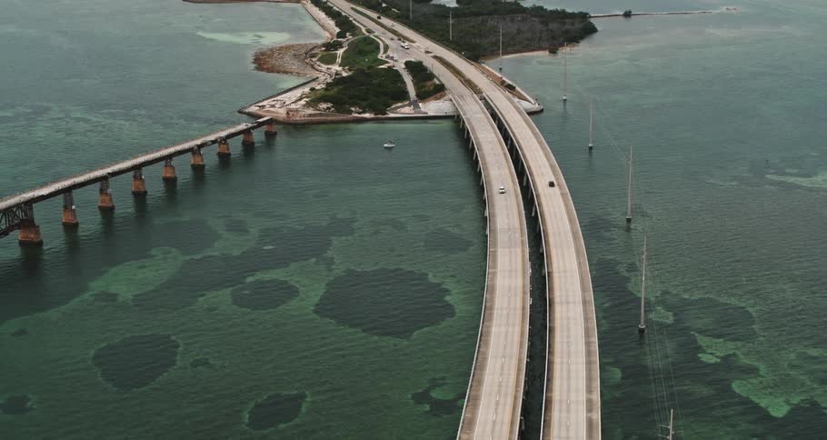 Cars traveling over a bridge spanning coastal islands