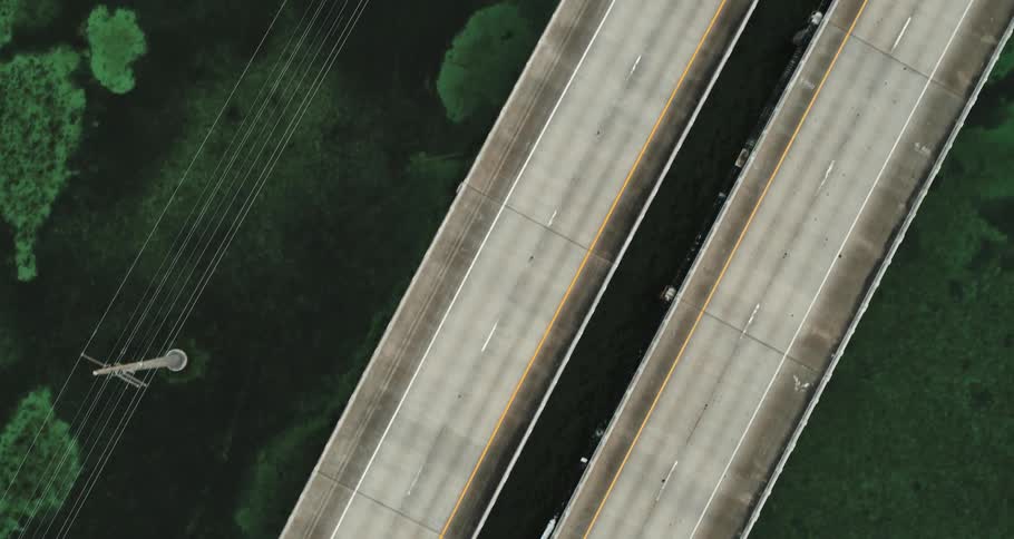 Aerial view of a double highway with a single car on the road