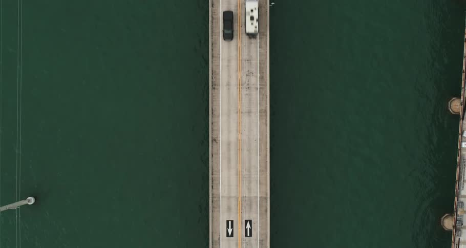 Cars travel across a bridge over water