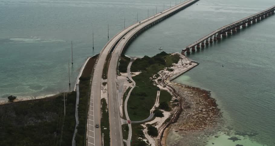 An aerial view of cars diving on a bridge over the water