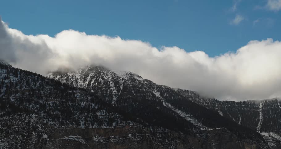 Clouds floating above a mountain landscape on a winter day