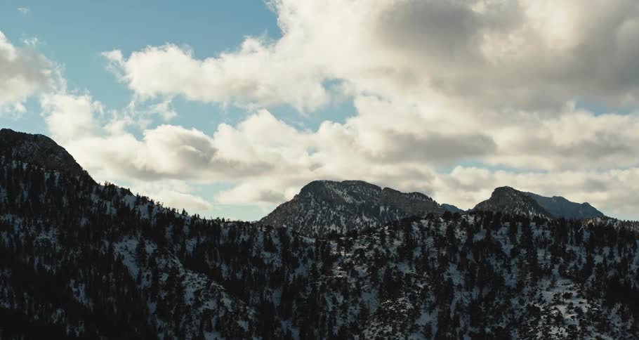 Clouds floating above a mountain landscape on a cold winter day