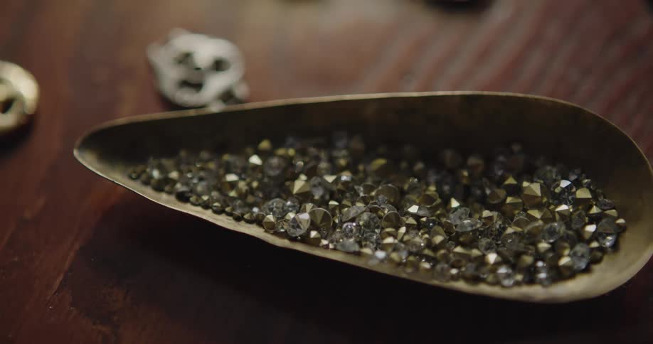 A bowl of gemstones sitting on a wood stable