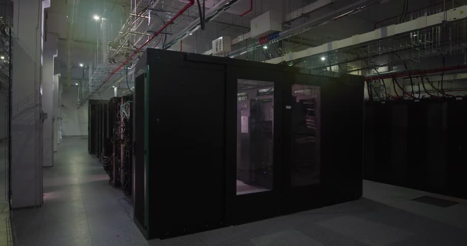 The server room is full of black racks
