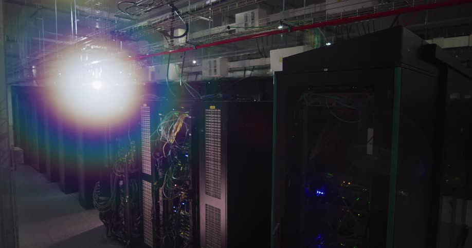 Computer servers fill a room with concrete floors