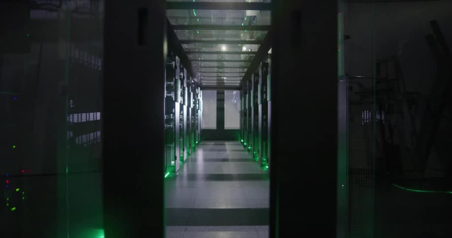 Doors close that lead to a hallway filled with electronic monitors and lights