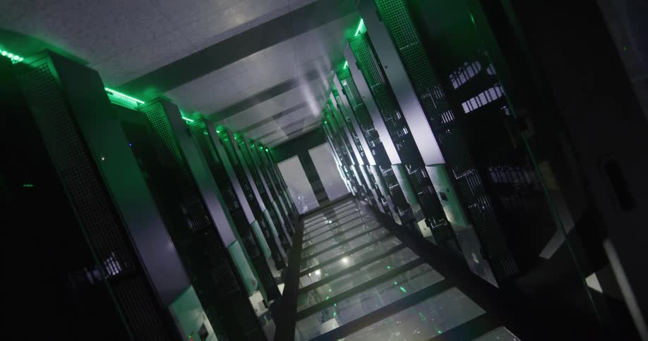 Green lights shine on servers lining corridor