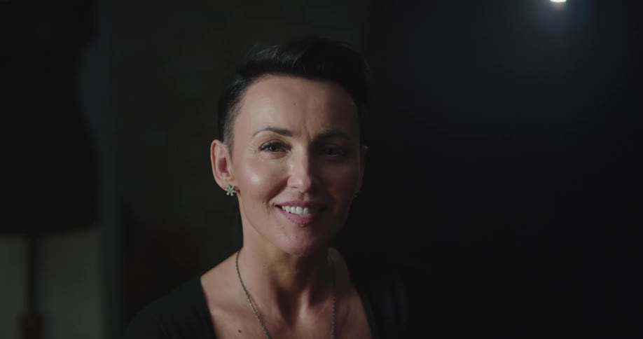 Short haired smiling woman looks at the camera