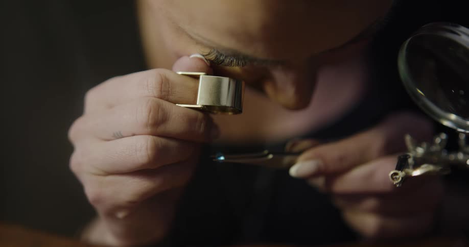 A jeweler examines a gemstone