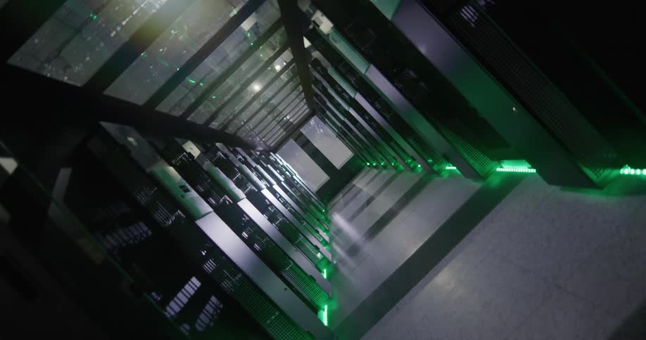 The camera twists around as the passageway between rows of computers servers can be seen