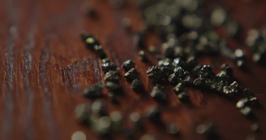Cut stones sit on a wood grain table