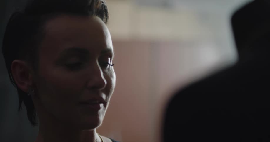 A portrait of a woman standing in a room