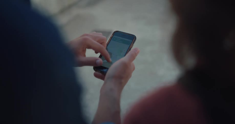A man and woman looking at things on a smartphone