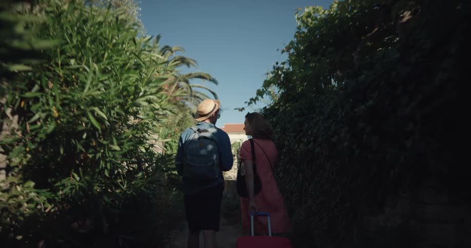 Young couple on vacation walking on a narrow passageway in a small town