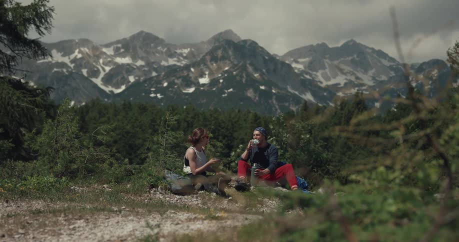 A couple are camping near the mountain range