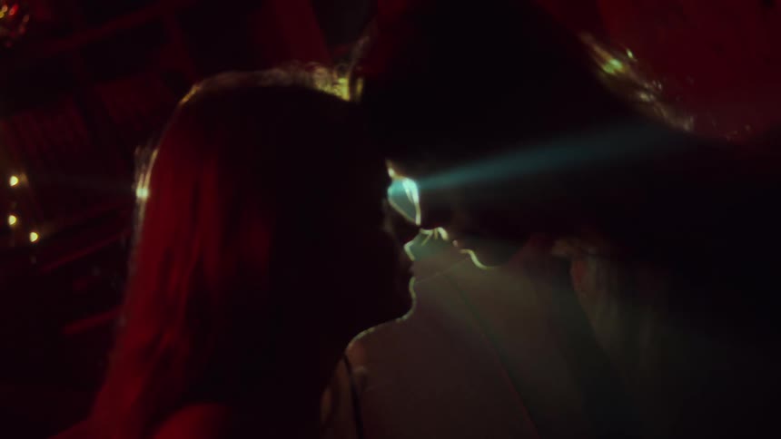 Two women move their heads close together so that they are nose to nose