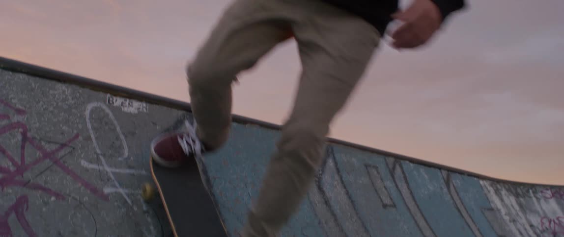 Male skateboards down an outdoor ramp