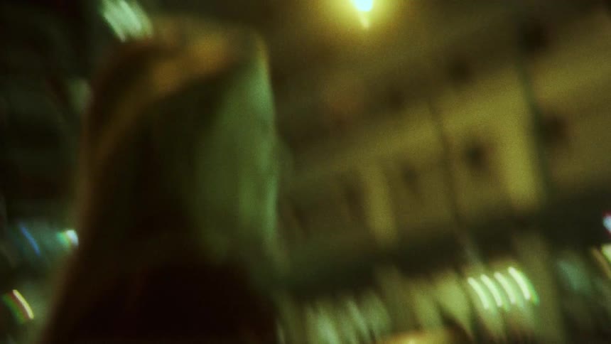 Two friends are outdoors in a downtown city at night