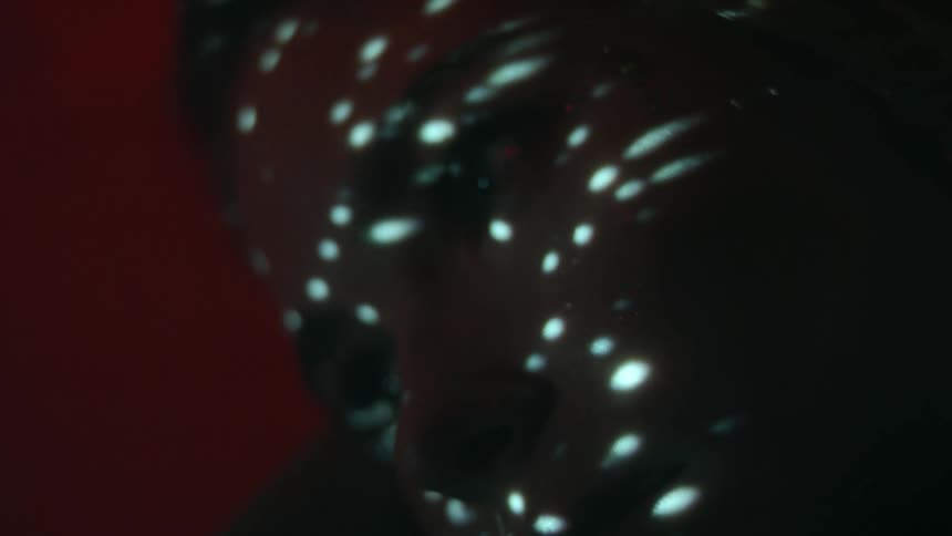 Light shimmers and dances across a dark gem stone