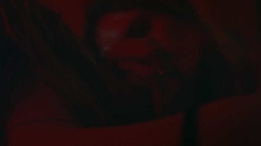 A woman smiling in the dark