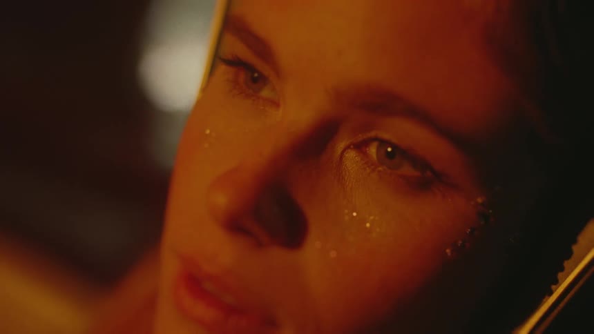 A woman with tears on her cheeks in darkness