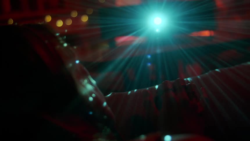 A projector is running in a darkened room