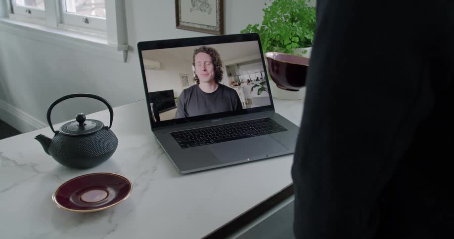 People talking on a video call through a laptop