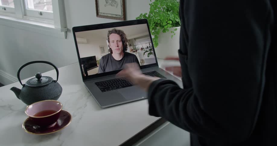 A person talking on a laptop