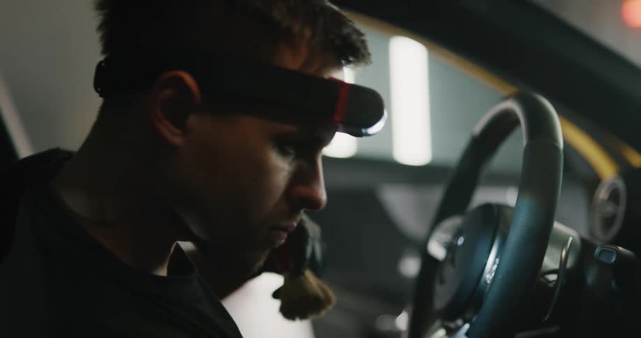 A man is cleaning the inside of the car