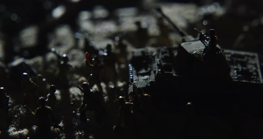 Toy army men with a toy tank