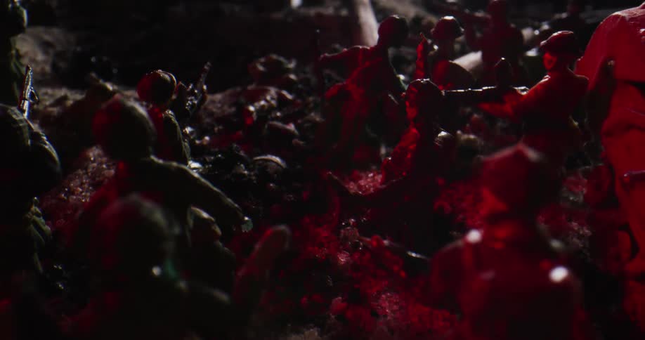 Toy soldiers are arranged in a battle formation outdoors